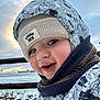 baby, beanie, bonnet, cap, clothing, coat, face, happy, hat, head, hood, jacket, knitwear, person, photography, portrait, smile, sweater, water, waterfront