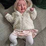 Mya joined the competition — help win amazing prizes! baby, infant, smiling, cute, headband, pink, white_jacket, fluffy, couch, cozy, happy, child, toddler, clothing, indoor, portrait, person, fabric, furniture, comfort