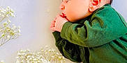 Muhammad joined the competition — help win amazing prizes! baby, newborn, sleeping, green_clothing, flowers, white_flowers, peaceful, infant, soft_light, portrait, side_view, cute, small_hands, delicate, nature, calm, resting, closeup, fresh, tender