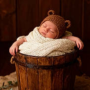 Kaylia participe au concours pour gagner de l'argent avec cette photo : baby, bear_ears, blanket, brown, child, cozy, cream, cute, decor, indoors, infant, knit_hat, knitted_toy, peaceful, portrait, sleeping, soft_texture, teddy_bear, wooden_bucket, wrapped