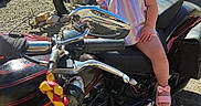 Amaya joined the competition — help win amazing prizes! toddler, child, motorcycle, sunglasses, outdoor, sunny, tree, van, pink_shoes, purple_bows, striped_dress, vehicle, handlebars, chrome, road, rock, shadow, person, summer, casual