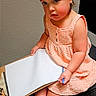 Amaya joined the competition — help win amazing prizes! toddler, child, girl, dress, headband, bow, clipboard, paper, sandals, chair, indoor, carpet, pink, peach, polka_dot, sitting, footwear, thoughtful, holding, person