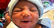Kasei joined the competition — help win amazing prizes! newborn, baby, smiling, face, hat, blanket, hand, person, indoors, clothing, portrait, sleepwear, cute, infant, cozy, expression, human, soft, wrapped, closeup