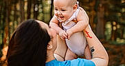 Grayson joined the competition — help win amazing prizes! baby, woman, child, outdoor, forest, trees, nature, smile, happy, holding, person, casual_clothing, daylight, portrait, family, parent, infant, skin, tattoo, blue_shirt