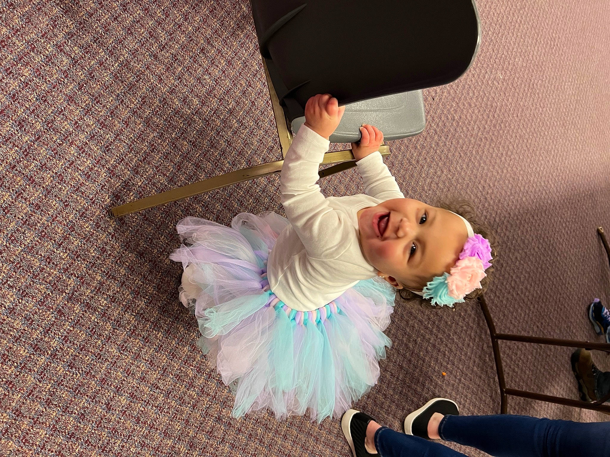 Avah is registered to the contest to win money with this photo: baby, baby_products, baby_toddler_clothing, ballet_tutu, child, comfort, dress, event, fashion_accessory, flooring, fun, happy, linens, magenta, person, pink, purple, room, smile, textile