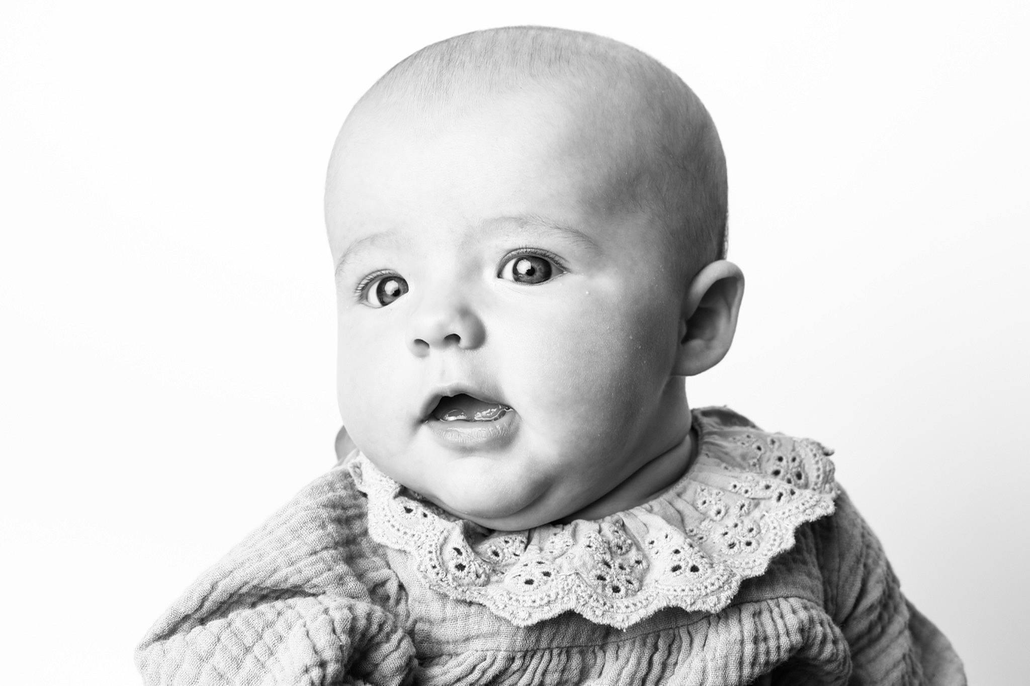 River is registered to the contest to win money with this photo: art, baby, baby_toddler_clothing, cheek, child, collar, eyelash, flash_photography, grey, happy, human_body, iris, monochrome, monochrome_photography, neck, nose, outerwear, person, sleeve, smile
