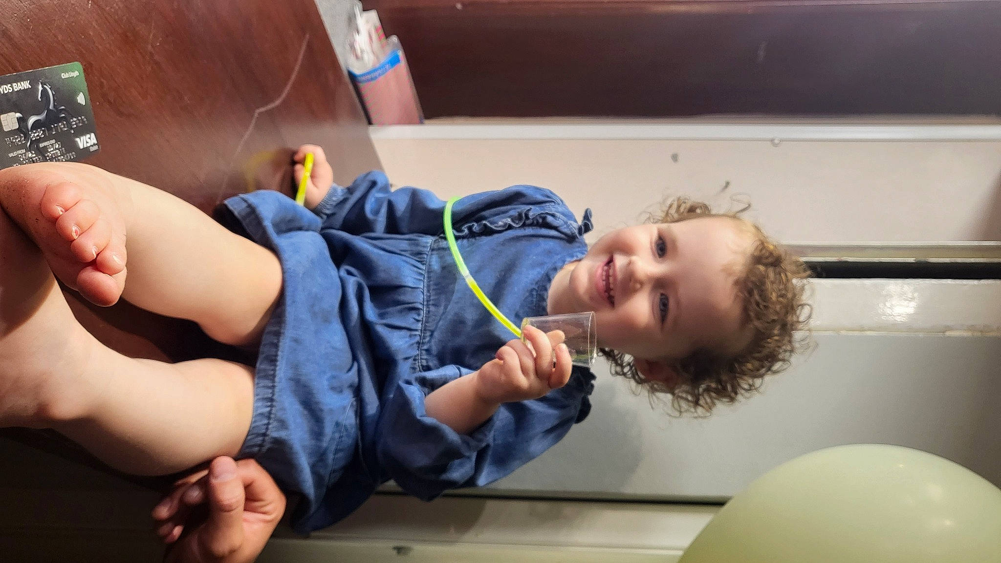 River is registered to the contest to win money with this photo: child, comfort, elbow, finger, fun, gesture, hand, happy, joint, joy, knee, leisure, person, room, sitting, smile, t_shirt, thigh, thumb, toddler