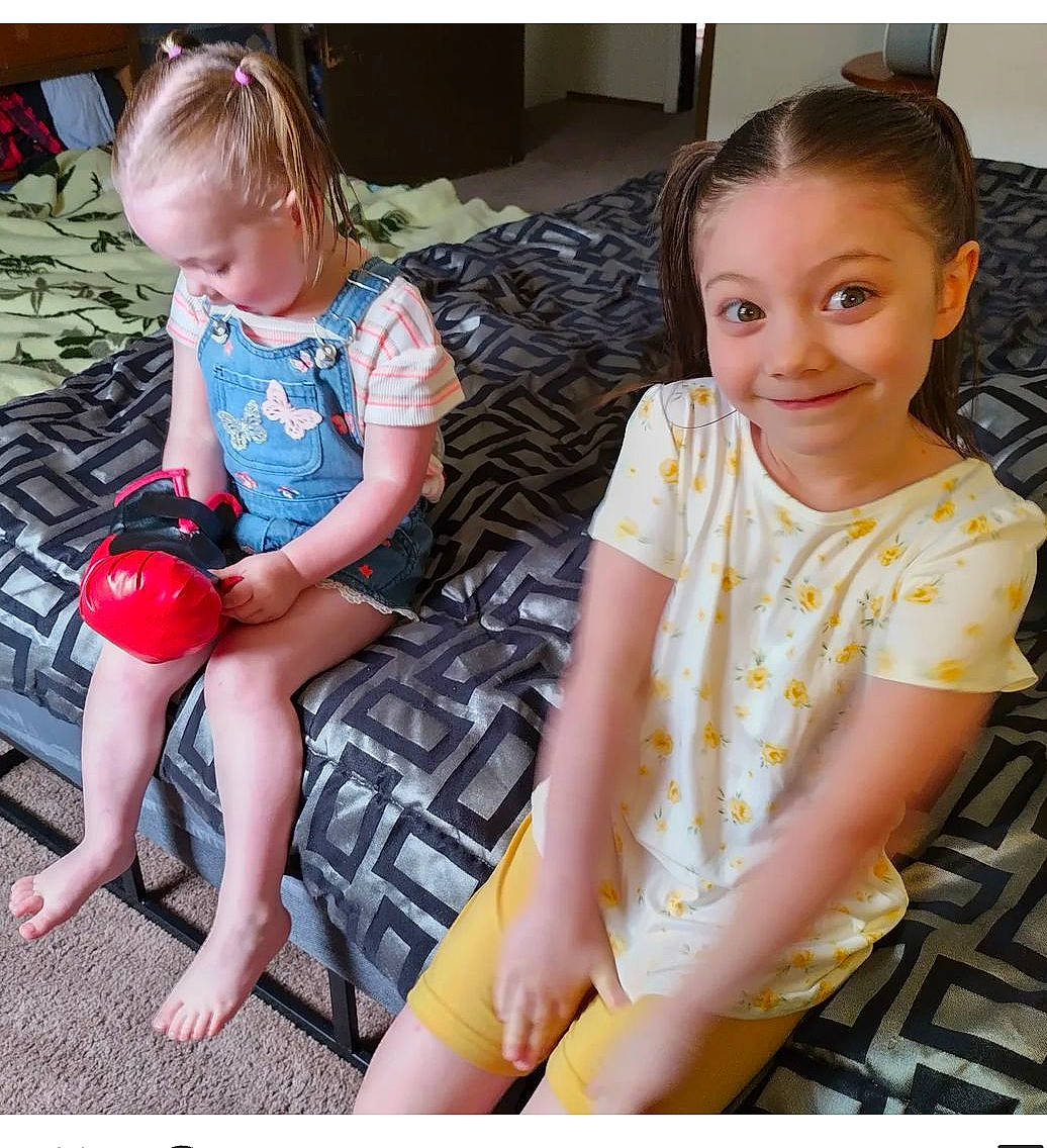 Lilly is registered to the contest to win money with this photo: baby_toddler_clothing, beauty, chair, child, comfort, foot, fun, happy, human_leg, joy, knee, lap, leisure, pattern, person, play, sandal, sitting, smile, t_shirt