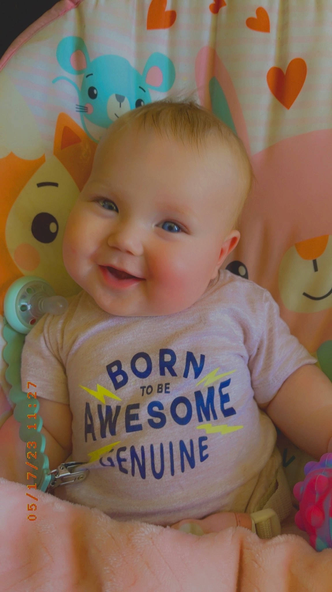Lynnzie is registered to the contest to win money with this photo: baby, baby_playing_with_toys, baby_products, baby_toddler_clothing, cheek, child, facial_expression, fun, happy, iris, joy, pattern, person, pink, product, sitting, skin, sleeve, smile, t_shirt