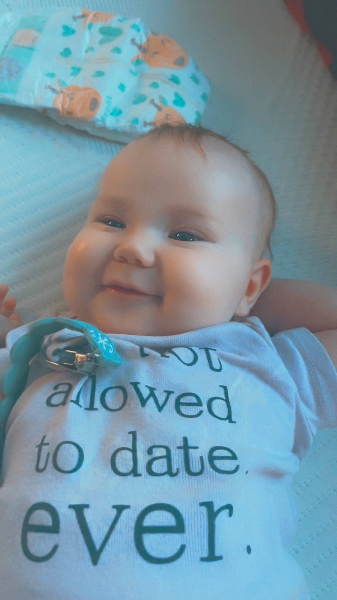 Lynnzie is registered to the contest to win money with this photo: azure, baby, baby_toddler_clothing, cheek, chin, eyebrow, facial_expression, finger, happy, human, iris, mouth, nose, person, pink, product, skin, sleeve, smile, textile