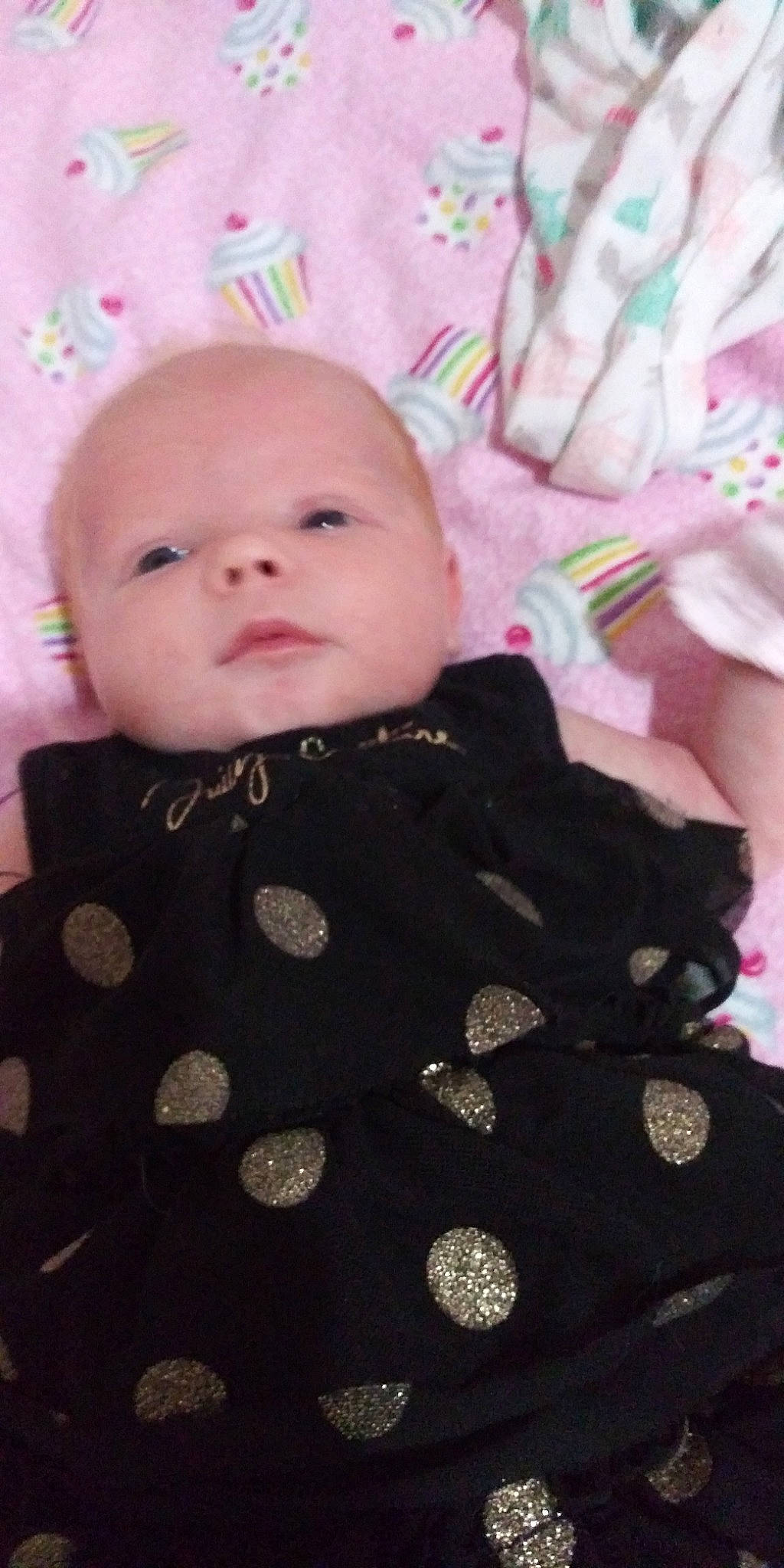 Emerie is registered to the contest to win money with this photo: baby, cheek, child, design, dress, eye, face, head, iris, lip, pattern, person, pink, polka_dot, skin, smile, textile, toddler