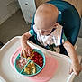 Théo a rejoint le concours — aidez-le/la à gagner de superbes lots ! toddler, child, high_chair, food, plate, corn, tomato, ham, scrambled_eggs, bib, green_shirt, kitchen, table, eating, meal, young_child, curious, indoor, person, baby