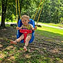 toddler, child, swing, outdoor, playground, trees, greenery, grass, sunlight, nature, smiling, blonde_hair, curly_hair, blue_swing, red_swing, barefoot, summer, park, happy, daytime