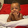 A Donis is registered to the contest to win money with this photo: baby, bed, bedroom, bodypart, couch, cushion, face, finger, furniture, hand, happy, head, homedecor, indoors, laughing, person, photography, portrait, room, smile