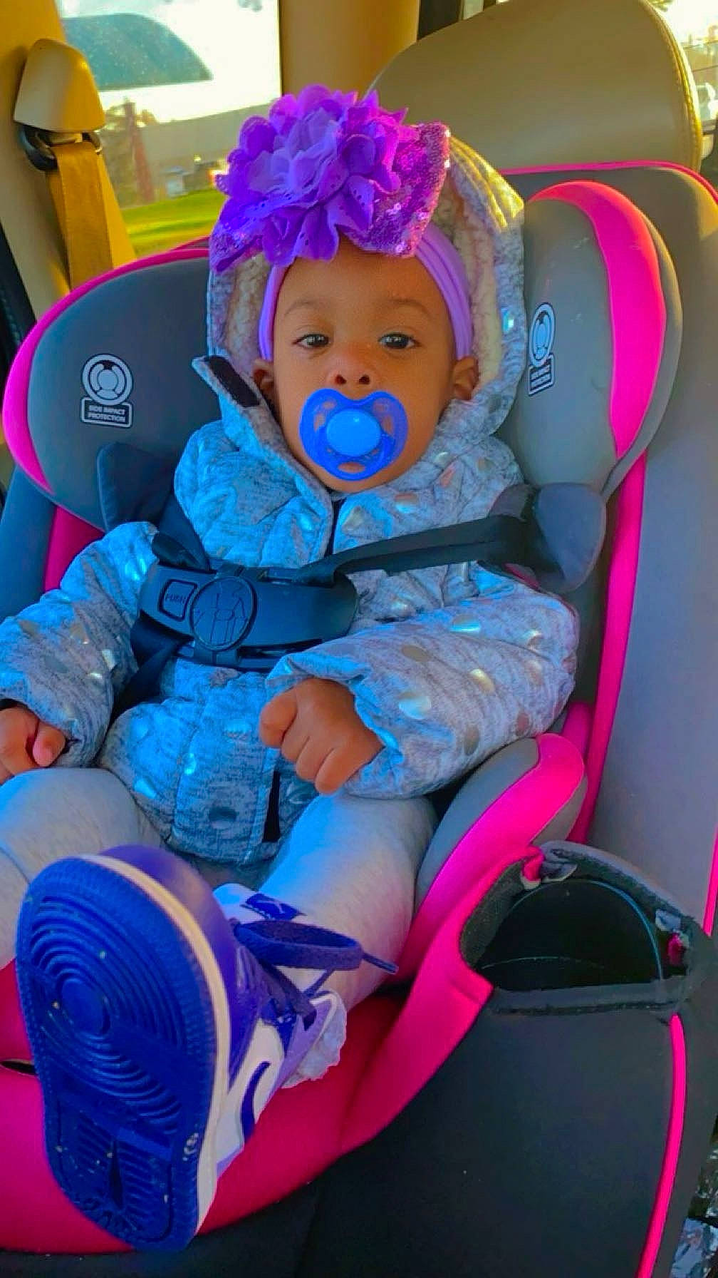 Braxtynn is registered to the contest to win money with this photo: baby, baby_products, baby_toddler_clothing, blue, car_seat, chair, cheek, child, comfort, electric_blue, face, fun, headwear, lap, magenta, person, personal_protective_equipment, pink, purple, sitting