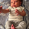 baby, infant, blanket, clothing, onesie, pants, foot, hand, face, head, skin, newborn, lying_down, soft_texture, cute, small, expression, indoors, portrait, baby_boy