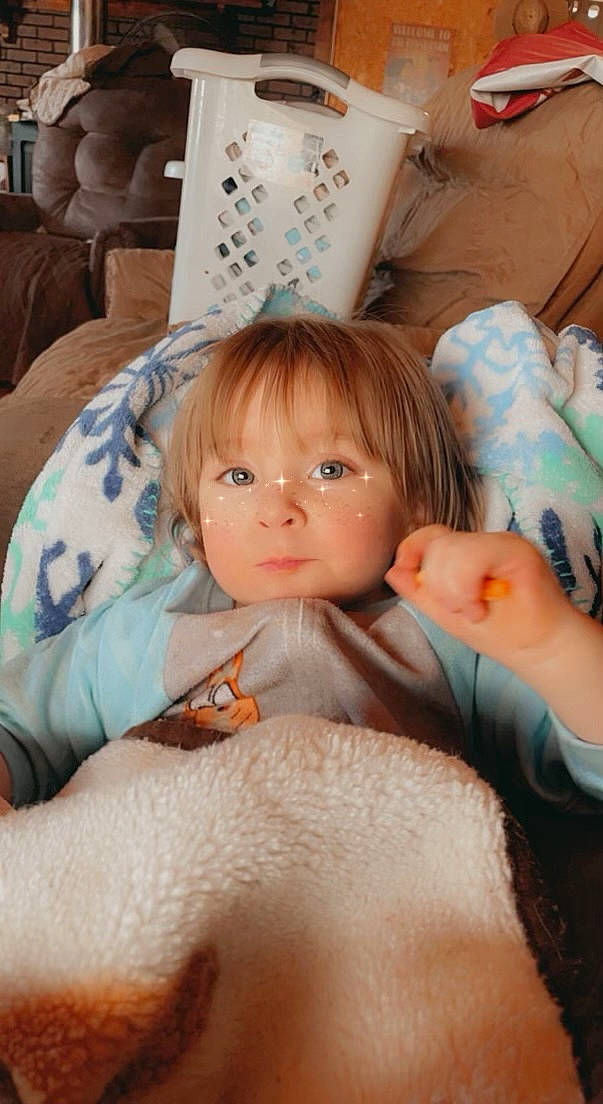 Jersey is registered to the contest to win money with this photo: abdomen, cheek, chest, child, comfort, cup, drinkware, event, eye, eyelash, finger, happy, human_body, linens, nail, person, serveware, textile, thumb, toddler