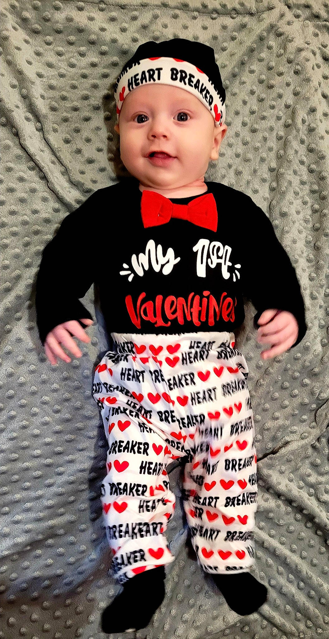 George is registered to the contest to win money with this photo: baby, baby_toddler_clothing, cap, child, cool, costume_hat, face, fashion_accessory, happy, hat, head, headwear, jersey, long_sleeved_t_shirt, military_camouflage, outerwear, pattern, person, sleeve, sportswear