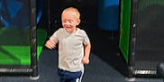 Samuel joined the competition — help win amazing prizes! active, blurry, boy, casual_clothing, child, floor, fun, indoor, movement, netting, pants, play_area, play_equipment, playground, running, shadow, smile, socks, tshirt, young
