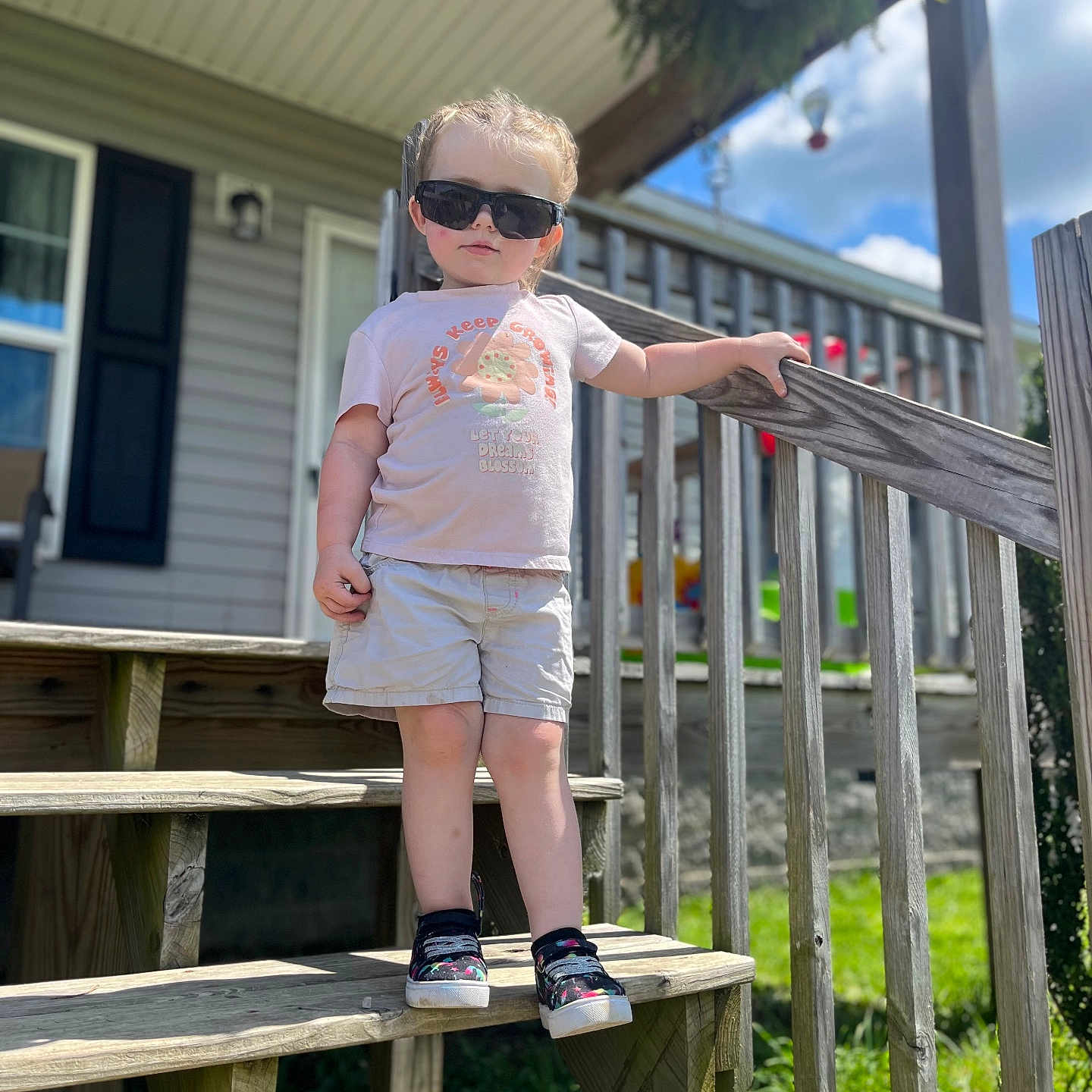 Adalynn is registered to the contest to win money with this photo: architecture, backyard, building, clothing, face, head, house, housing, nature, outdoors, person, photography, plant, porch, portrait, pottedplant, shelter, shorts, summer, t_shirt