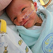 Ezra joined the competition — help win amazing prizes! baby, bed, blanket, closeup, clothing, comfort, cute, face, hand, hospital, infant, medical_tape, nasal_tube, newborn, person, portrait, sleepwear, smile, soft_texture, toddler