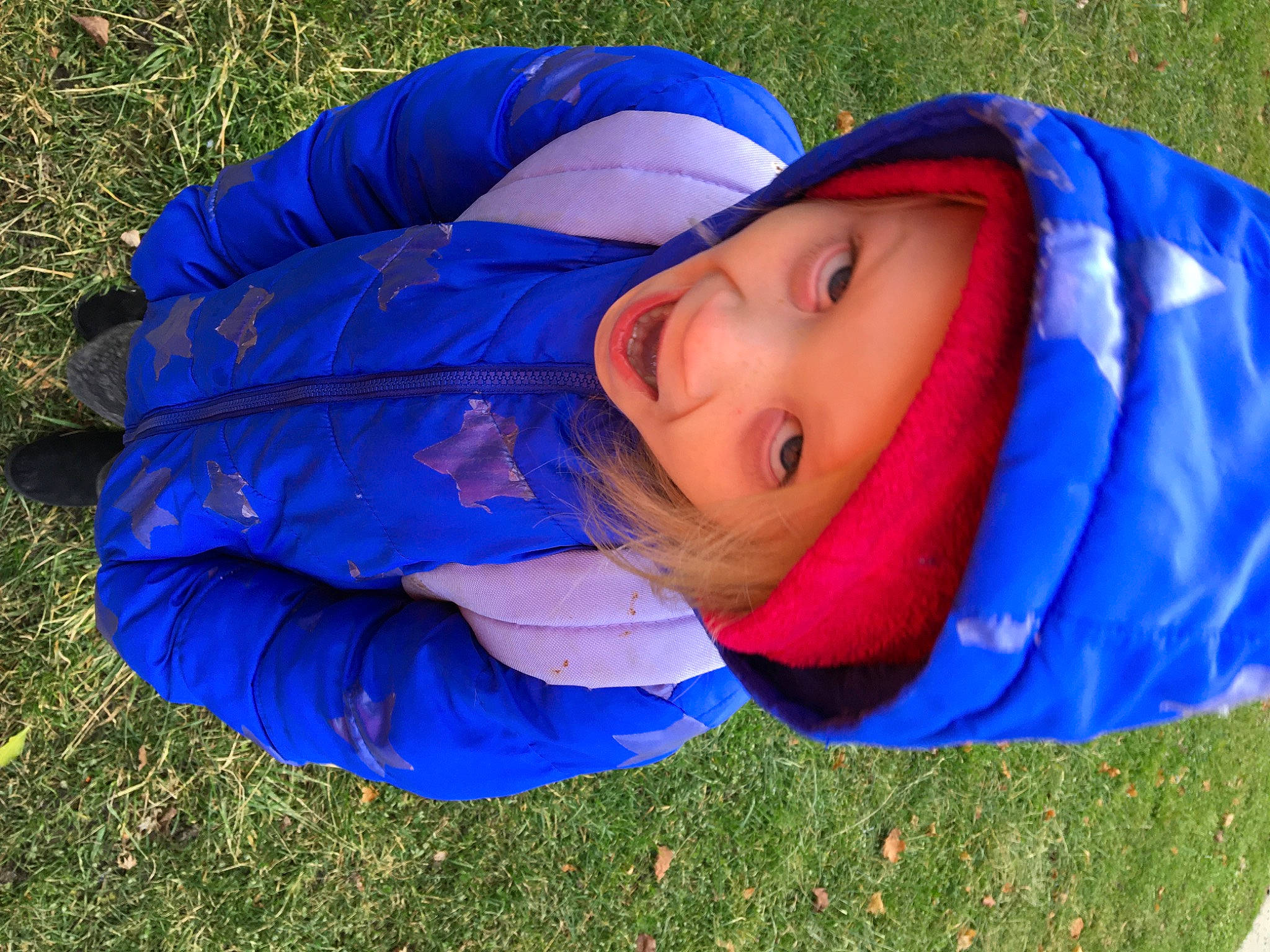 Emily is registered to the contest to win money with this photo: baby, baby_toddler_clothing, blue, cobalt_blue, electric_blue, headwear, hood, jacket, people_in_nature, person, windbreaker