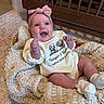 Baylyn joined the competition — help win amazing prizes! baby, infant, smiling, headband, bow, blanket, basket, crib, wooden_furniture, clothing, socks, happy, indoor, floor, rug, cute, portrait, child, newborn, cozy