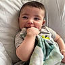 Cooper joined the competition — help win amazing prizes! baby, child, smiling, blanket, hand, face, pillow, cute, infant, resting, clothing, indoors, portrait, happy, young, teething, soft, comfort, closeup, babywear