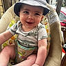 Cooper joined the competition — help win amazing prizes! baby, child, smiling, hat, bucket_hat, onesie, dinosaur_pattern, baby_chair, colorful, patterned, indoor, happy, cute, portrait, infant, clothing, seat, person, young_child, cozy