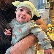 Cooper joined the competition — help win amazing prizes! baby, child, adult, glasses, long_hair, beard, hat, yoda, smile, indoor, water_cooler, holding, clothing, sitting, person, arm, toy, furniture, floor, portrait