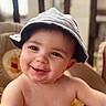 baby, child, smile, hat, face, infant, cute, messy, chair, cushion, indoors, portrait, happy, skin, headwear, young, person, closeup, seat, expression