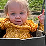 toddler, child, swing, playground, yellow_dress, pony_tail, outdoor, sunny, grass, happy, smiling, person, face, hand, metal, clothing, daytime, nature, cute, young