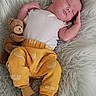 adorable, baby, child, comfort, cozy, cuddly_toy, cute, gray_socks, indoors, infant, newborn, peaceful, portrait, relaxing, resting, sleeping, soft_texture, teddy_bear, white_blanket, yellow_pants