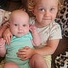 baby, blanket, child, couch, cozy, curly_hair, cute, face, family, holding, indoor, onesie, person, portrait, sitting, skin, smile, socks, soft_lighting, toddler