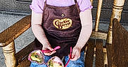 Karlene is registered to the contest to win money with this photo: apron, bow, casual_clothing, child, curious, floor, hair, indoor, jeans, person, pink, portrait, purple, rocking_chair, seated, shoes, sunglasses, texture_effect, toddler, wood