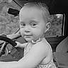 toddler, child, car, steering_wheel, interior, seat, window, curly_hair, dress, portrait, cute, baby, expression, seatbelt, dashboard, monochrome, black_and_white, hand, looking, vehicle