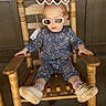 baby, casual, child, cute, fashion, floral_outfit, heart_sticker, outdoor, playful, porch, reflection, rocking_chair, shoes, sitting, socks, sunglasses, sunny, toddler, window, wooden_chair