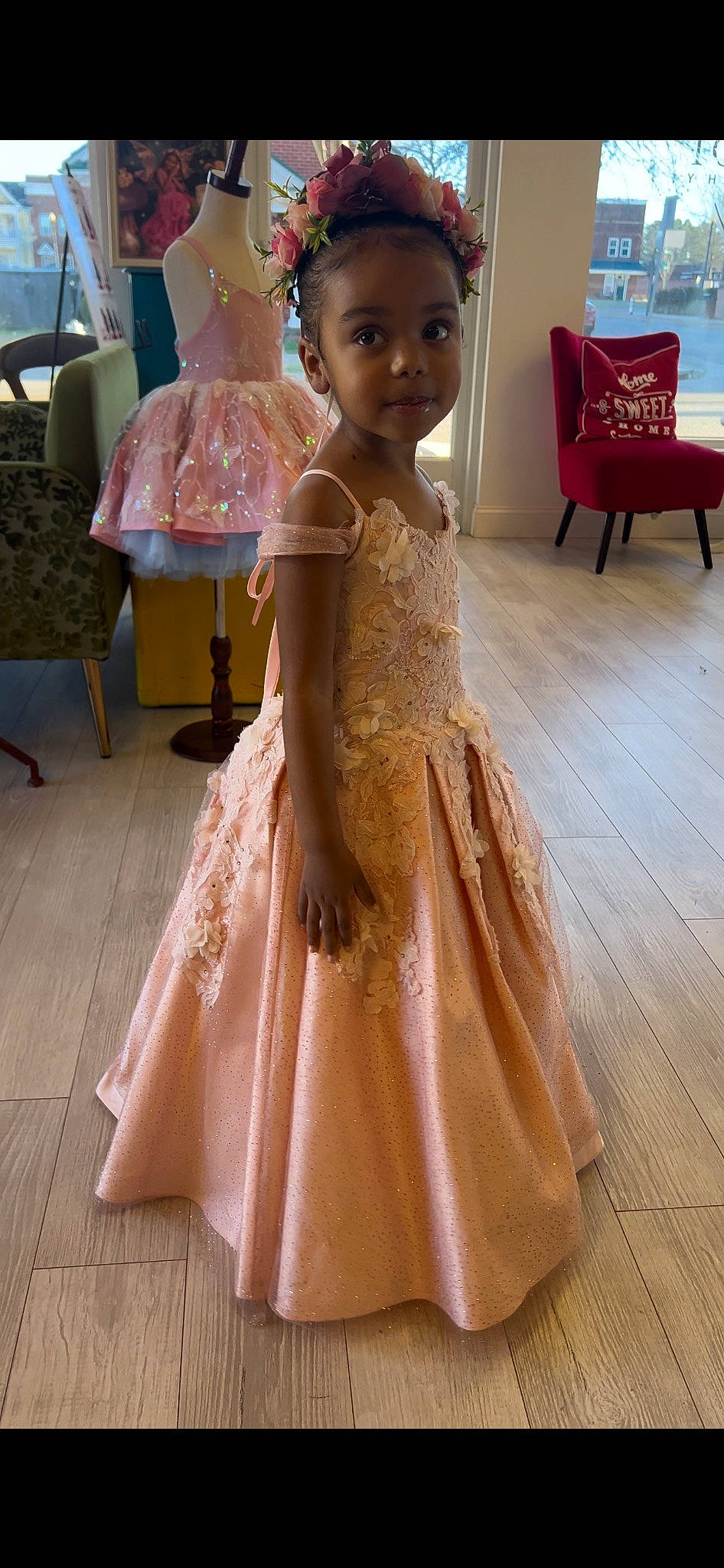 Skylar joined the competition — help win amazing prizes! bridal_accessory, bridal_clothing, bridal_party_dress, chair, day_dress, dress, embellishment, event, fashion_accessory, fashion_design, flooring, formal_wear, gown, happy, one_piece_garment, peach, person, pink, smile, toddler