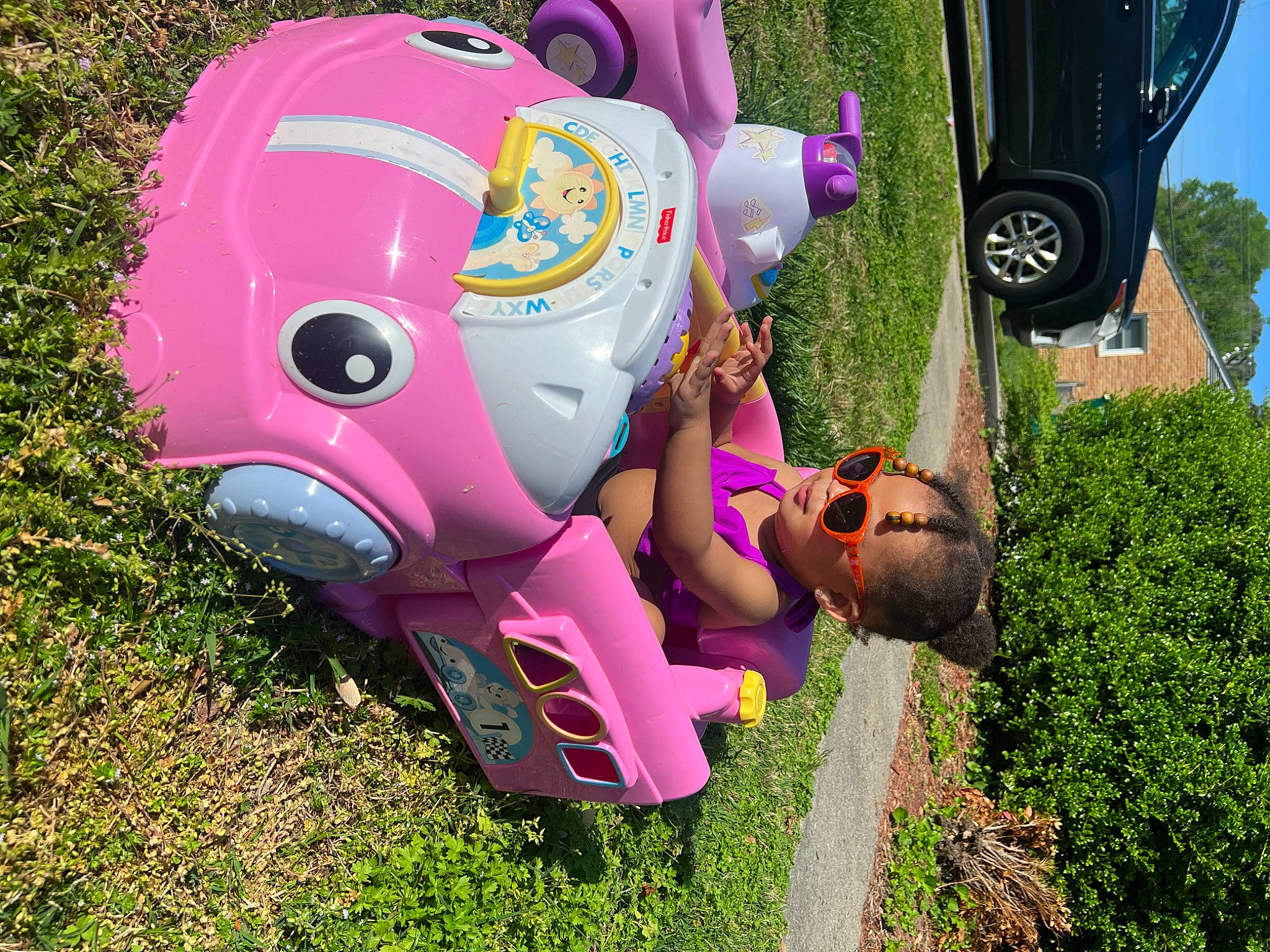 Journi is registered to the contest to win money with this photo: automotive_design, automotive_tire, car, fender, grass, hat, helmet, leisure, magenta, motor_vehicle, motorcycle_helmet, person, personal_protective_equipment, pink, plant, sunglasses, tire, toy, tree, vehicle