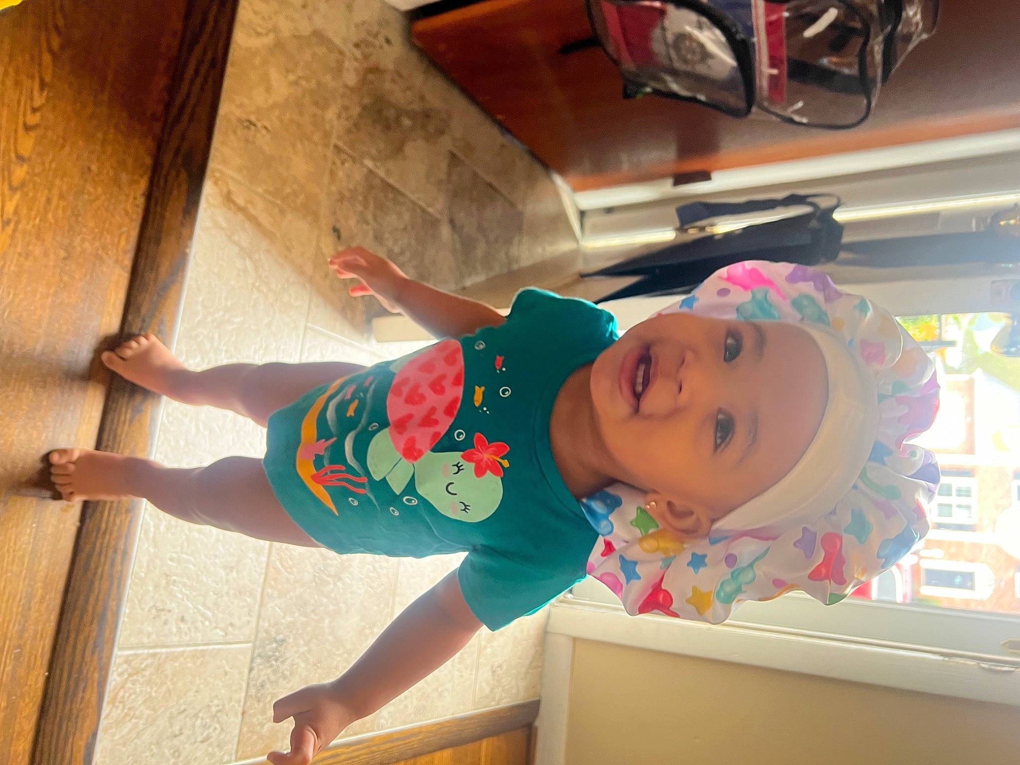 Journi joined the competition — help win amazing prizes! baby, baby_toddler_clothing, barefoot, child, elbow, flooring, foot, fun, happy, hardwood, hat, headwear, human_leg, leisure, person, play, room, smile, thigh, toddler