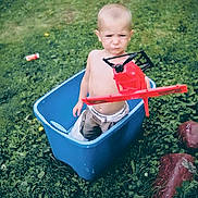 Rylan joined the competition — help win amazing prizes! bare_chest, casual, child, fun, grass, greenery, helicopter, kid, lawn, nature, outdoor, plastic, plastic_bin, play, serious_face, shirtless, summer, toddler, toy, young_child