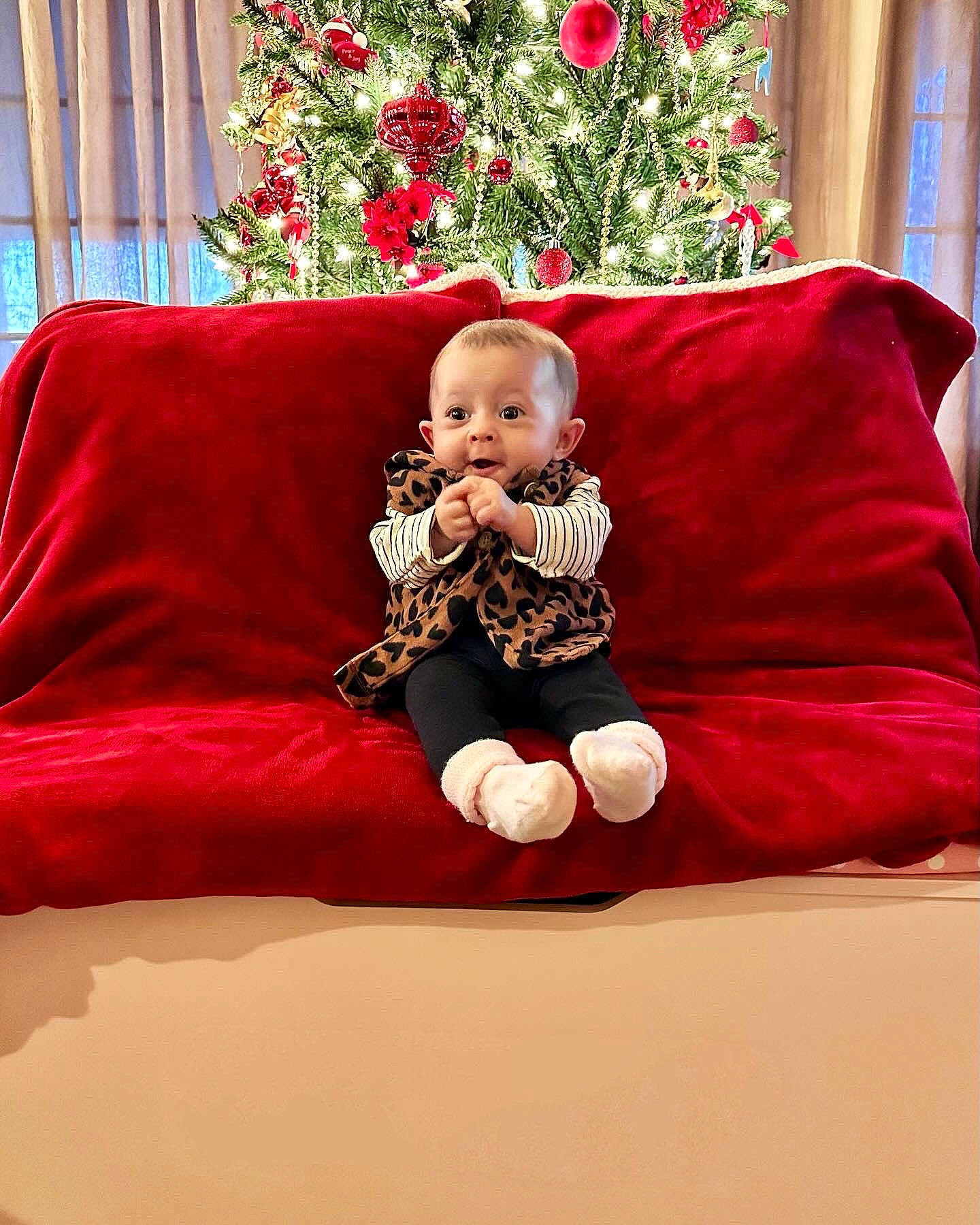 Rya joined the competition — help win amazing prizes! baby, child, christmas_decoration, comfort, couch, event, eye, flooring, flower, furniture, holiday, lap, mammal, ornament, person, plant, red, room, sitting, sleeve