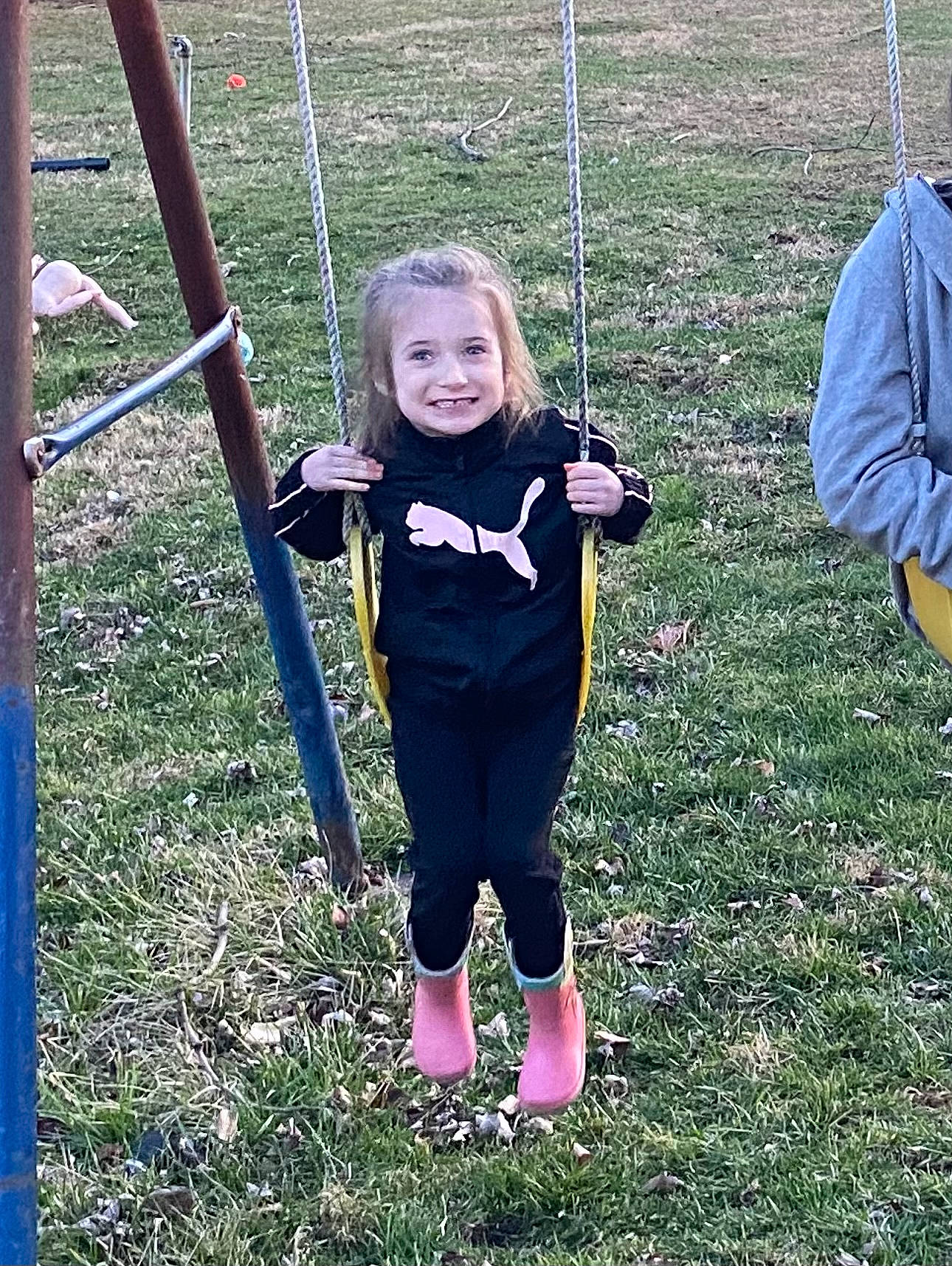 Edith is registered to the contest to win money with this photo: child, city, event, fun, grass, grassland, happy, joy, leisure, outdoor_play_equipment, people_in_nature, person, plant, play, playground, recreation, sleeve, smile, swing, t_shirt