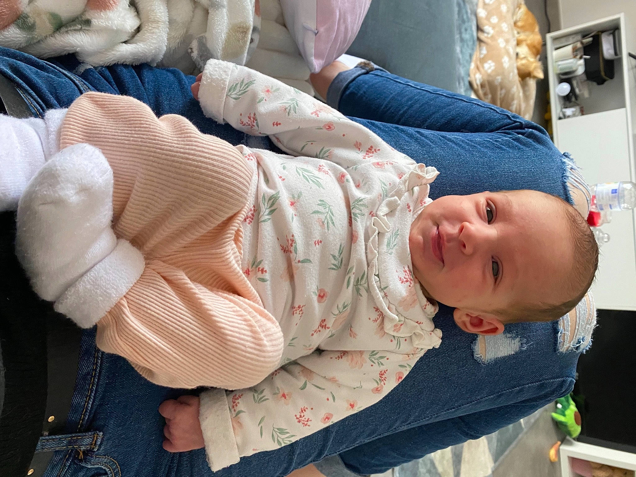 Rose participe au concours pour gagner de l'argent avec cette photo : abdomen, baby, baby_products, baby_toddler_clothing, child, comfort, couch, hat, human_leg, lap, linens, mammal, mouth, pattern, person, sitting, sleeve, smile, textile, thigh