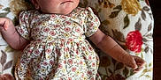 Rosaleigh joined the competition — help win amazing prizes! baby, infant, child, floral_dress, blanket, pattern, flower, laying_down, cute, skin, face, expression, hand, arm, leg, indoors, soft_texture, young, portrait, relaxing