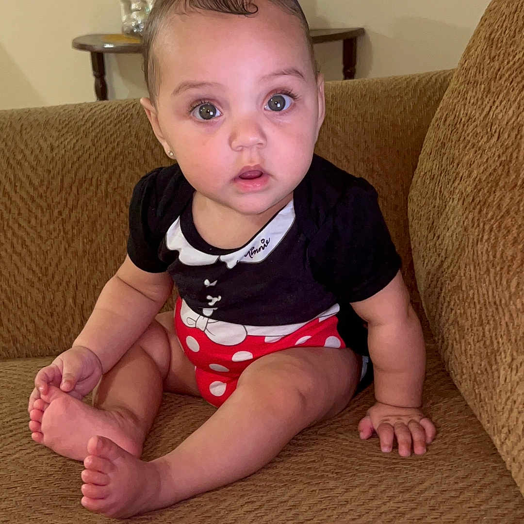 Milayshka joined the competition — help win amazing prizes! baby, barefoot, black_clothing, brown_furniture, casual, ceramic_figures, child, couch, curly_hair, cute, expression, home, indoor, person, polka_dot, pregnant_belly, red_clothing, sitting, table, wide_eyes