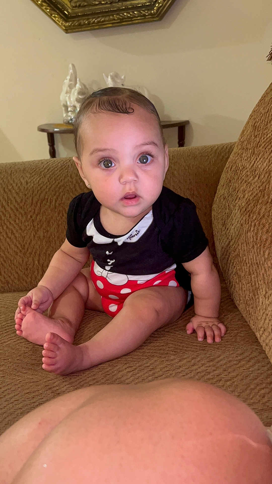 Milayshka joined the competition — help win amazing prizes! baby, child, couch, indoor, person, sitting, black_clothing, red_clothing, polka_dot, barefoot, pregnant_belly, table, ceramic_figures, brown_furniture, curly_hair, wide_eyes, expression, home, casual, cute