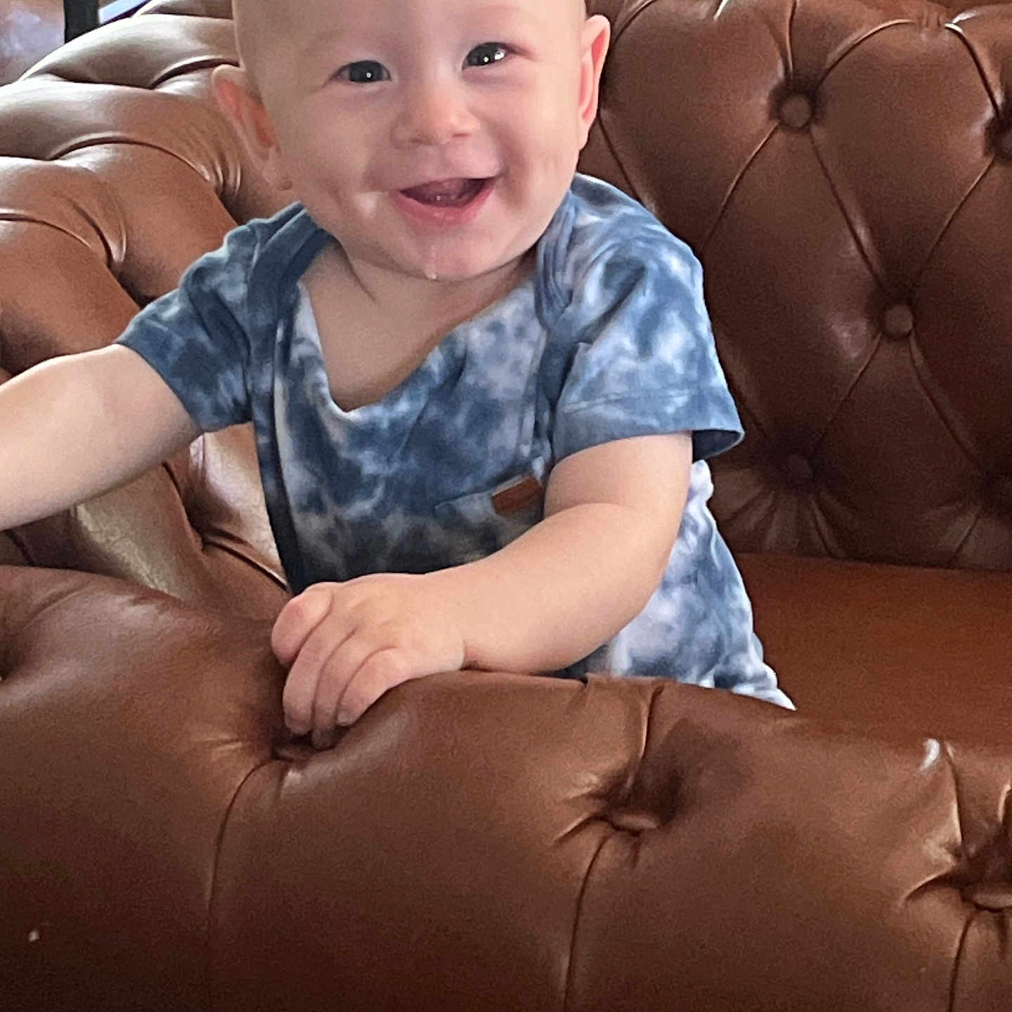 Oliver joined the competition — help win amazing prizes! architecture, baby, babylaughing, building, chair, clothing, couch, cushion, face, furniture, happy, head, homedecor, laughing, person, photography, portrait, sitting, smile, t_shirt