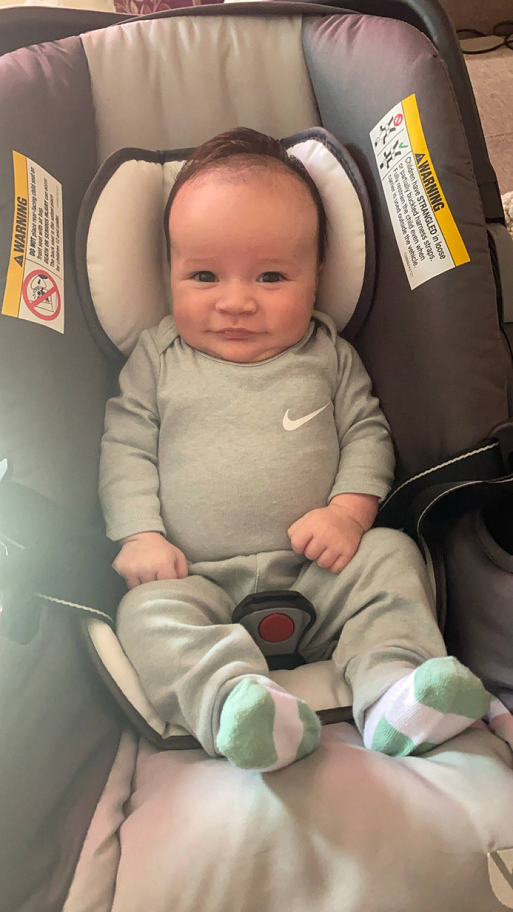 Austin is registered to the contest to win money with this photo: baby, clothing, cushion, face, furniture, happy, head, homedecor, hosiery, newborn, pants, person, photography, portrait, sitting, smile, sock, t_shirt, transportation, vehicle