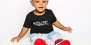 Ember is registered to the contest to win money with this photo: toddler, child, smiling, red_bow, black_tshirt, jeans, frills, red_shoes, sitting, white_bench, portrait, cute, happy, fashion, studio, young_child, accessories, casual_clothing, playful, bright